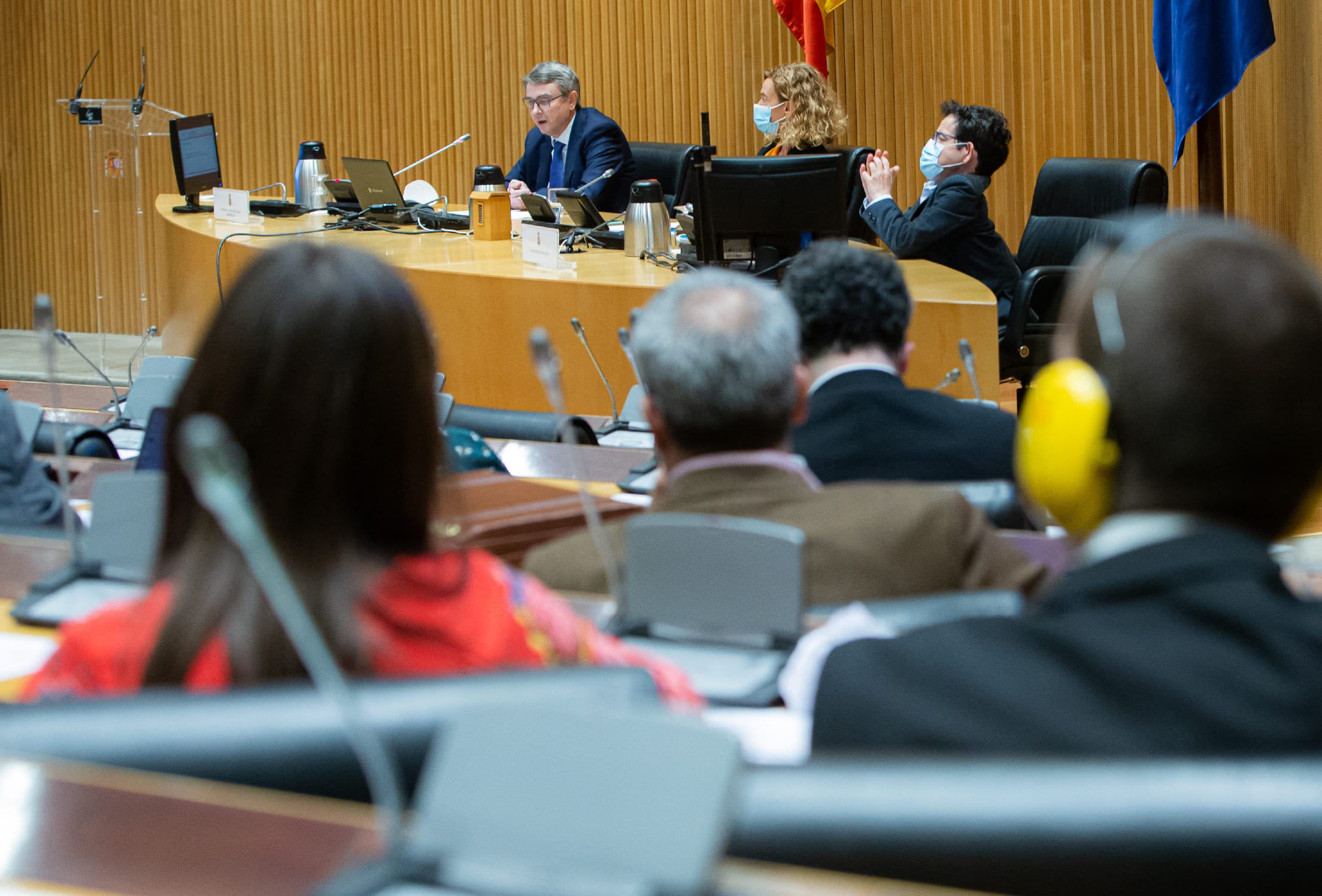 Fotografía de un evento en el que hay tres personas presentando ante una multitud