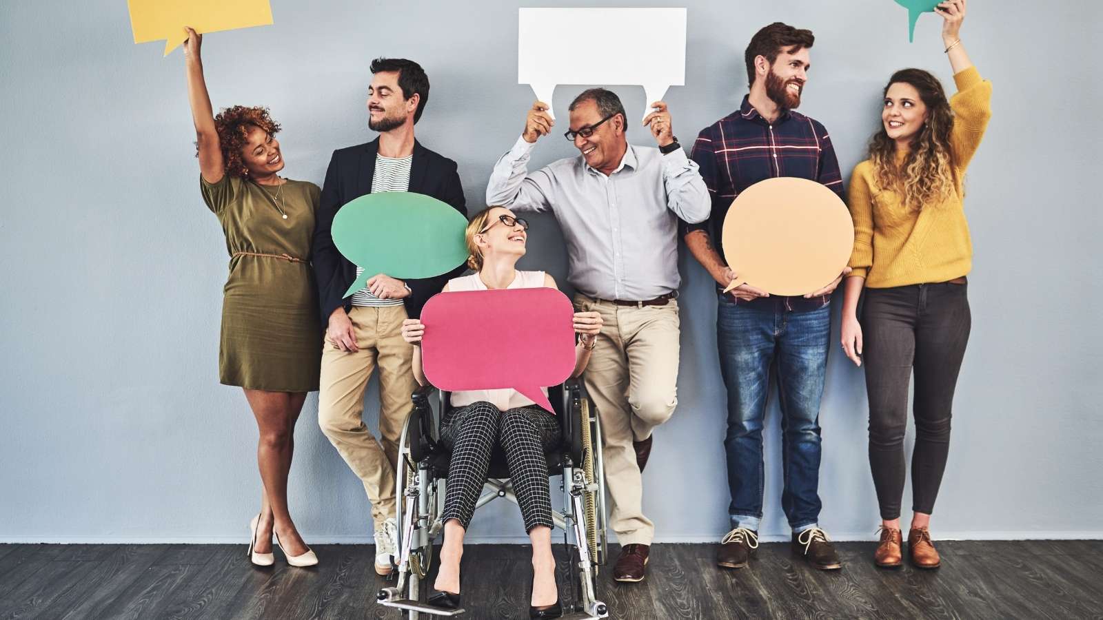 Miniatura de un grupo de personas con carteles de colores en la mano