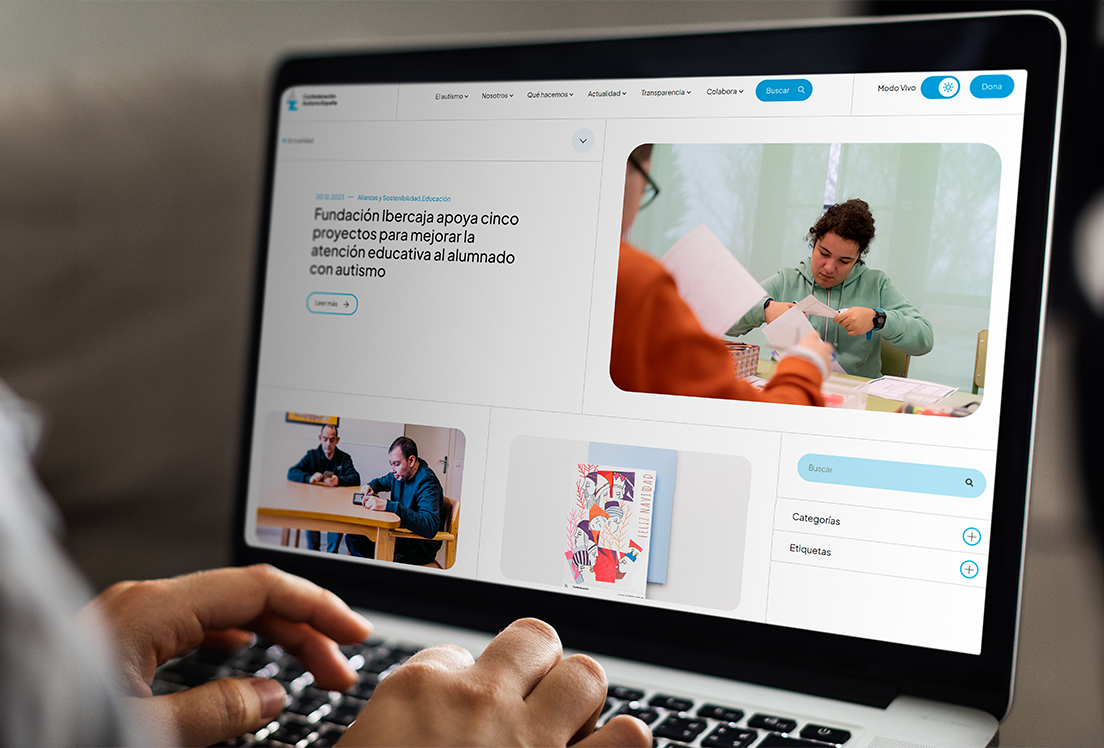 Unas manos tecleando en un ordenador en el que se ve el blog de Autismo España